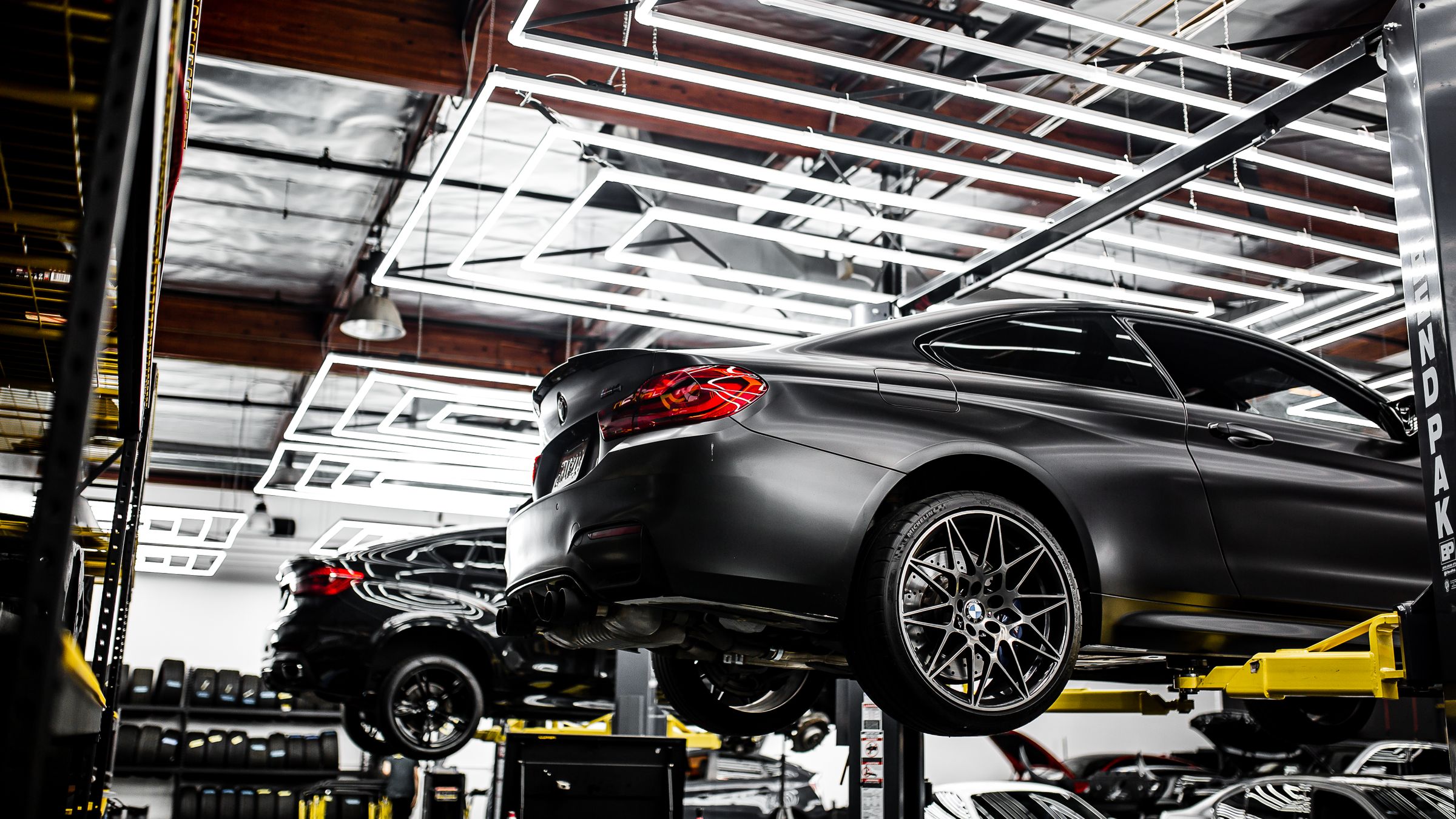 Cars on lifts in a modern workshop