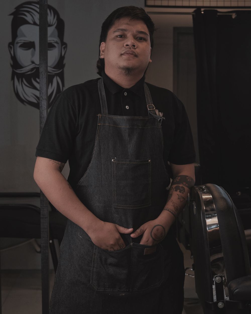Barber in an apron at his barbershop